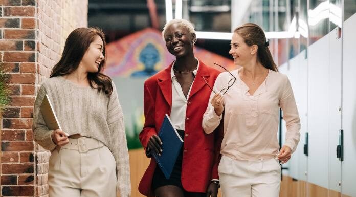 Top 6 Lucrative Industries for Women Entrepreneurs in Virginia Three businesswomen walking and talking in a hallway